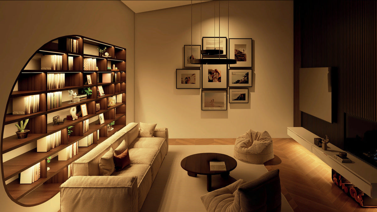 Living room shown with warmer white lighting around integrated shelving.