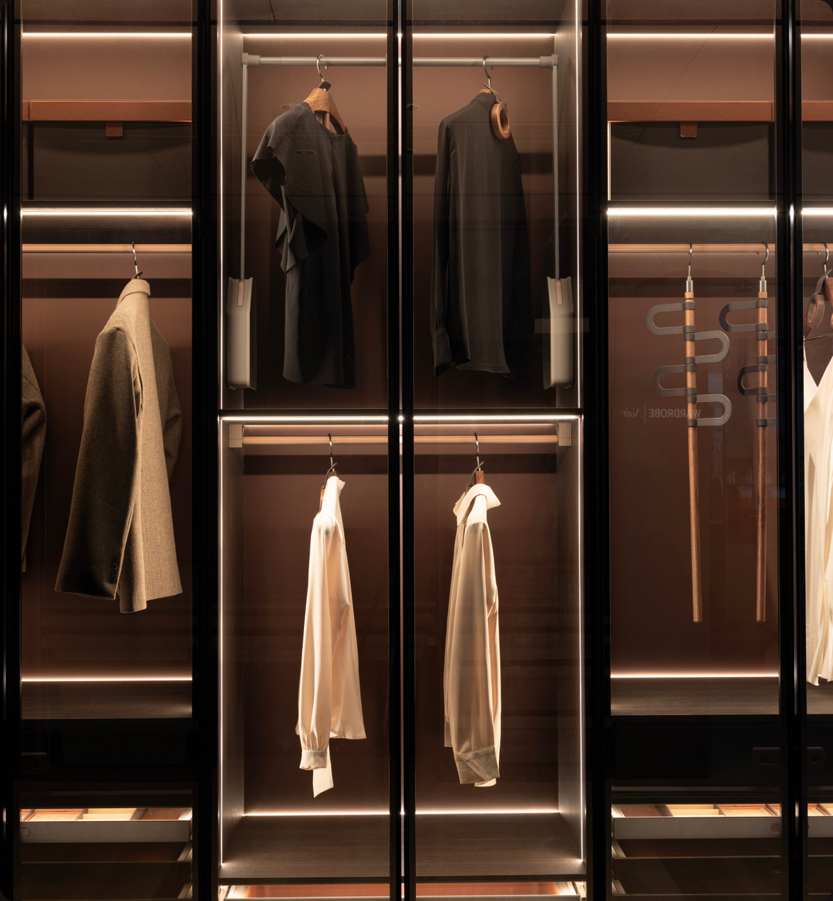 Illumination builds across the wardrobe interior